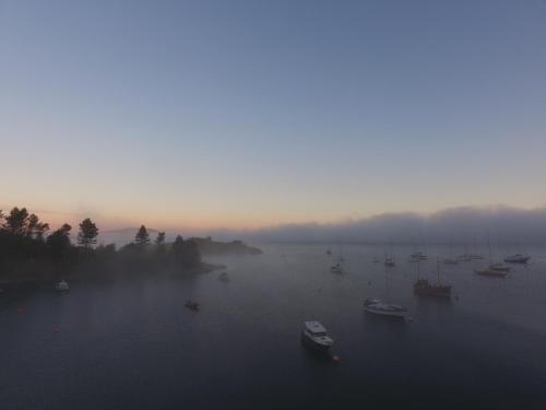 a group of boats floating on a large body of water at Crinan Hotel in Crinan