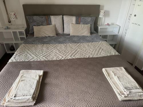 a large bed in a room with two baskets on it at La dogana in Siena