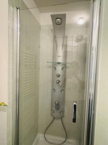 a shower with a shower head in a bathroom at LA DOGANA . in Siena