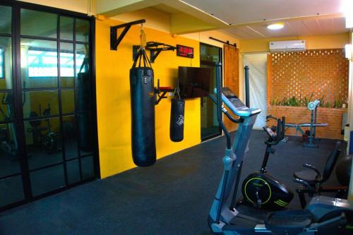 a gym with two boxing bags hanging on a wall at AkiraSunRice Villa calme, jardin et rizières in Phra Nakhon Si Ayutthaya