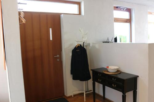 a room with a wooden door and a black cabinet at Stadtvilla in Murnau am Staffelsee