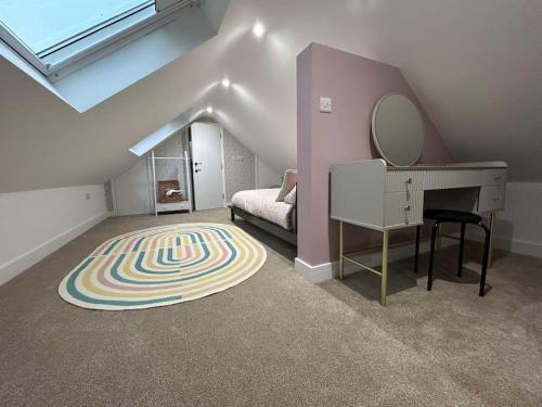 a attic room with a dressing table and a mirror at Spitfire View in Aldington