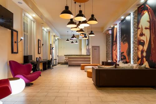 a lobby with couches and chairs in a building at Full Moon Budapest in Budapest