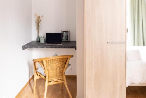 a room with a desk and a chair next to a bed at Le Luminosa - Centre Ville - 6 pers in Haguenau