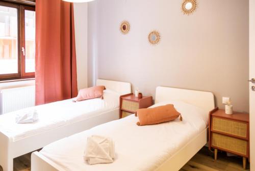 a room with two beds and a window at Le Luminosa - Centre Ville - 6 pers in Haguenau