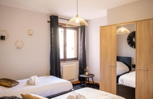 a bedroom with two beds and a window at Le Luminosa - Centre Ville - 6 pers in Haguenau