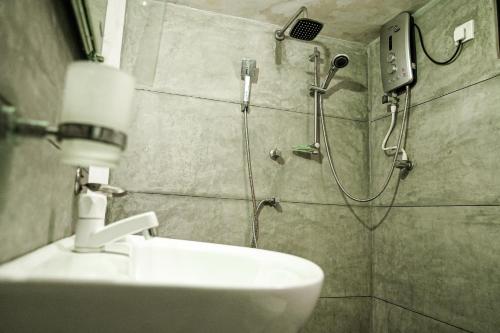 a bathroom with a shower and a sink at Singhe House in Dickwella