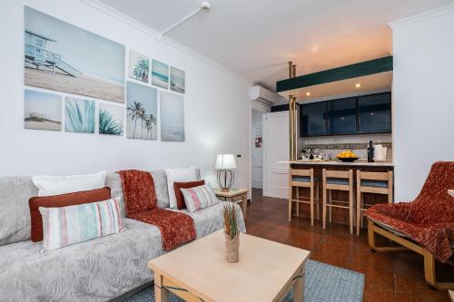 a living room with a couch and a table at Parque dos Reis Apartment in Monte Gordo