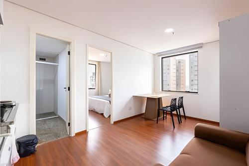 a living room with a couch and a table at Flats Osasco Trade Center in Osasco