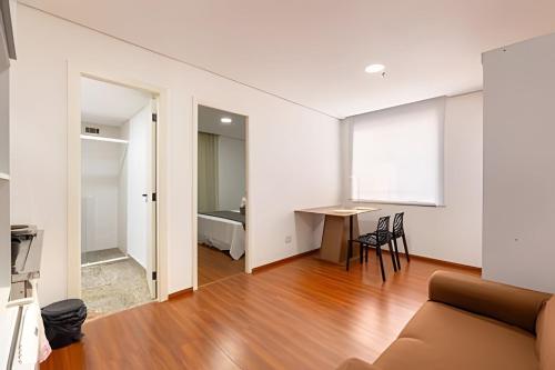 a living room with a couch and a table at Flats Osasco Trade Center in Osasco
