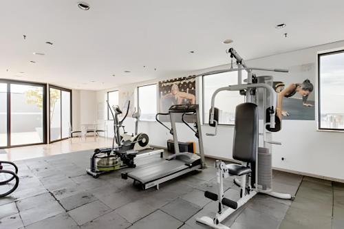 a gym with two people on tread machines in a room at Flats Osasco Trade Center in Osasco