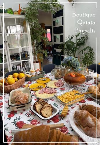 a table full of food and bread and other foods at Boutique Quinta Physalis in Fenais da Luz