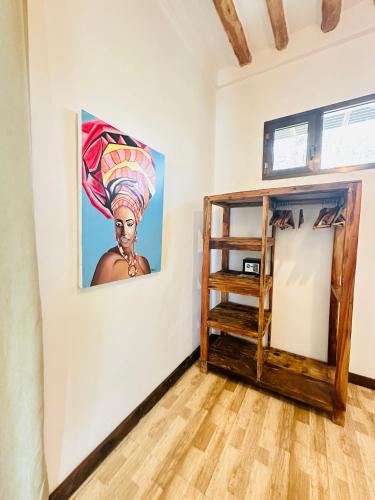 a room with a painting of a woman on a wall at Z-Breeze Zanzibar in Kiwengwa