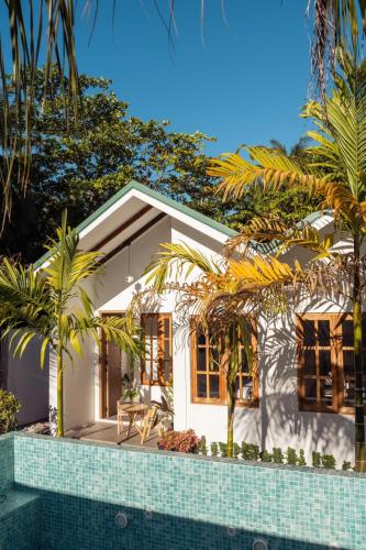 a house with a swimming pool in front of it at Kondey Villas in Kondey