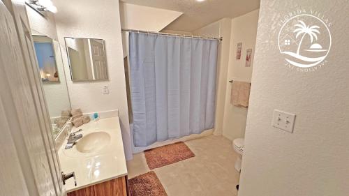 a small bathroom with a sink and a shower at Villas Standard Seven Dwrafs Resort - Close to Disney in Kissimmee