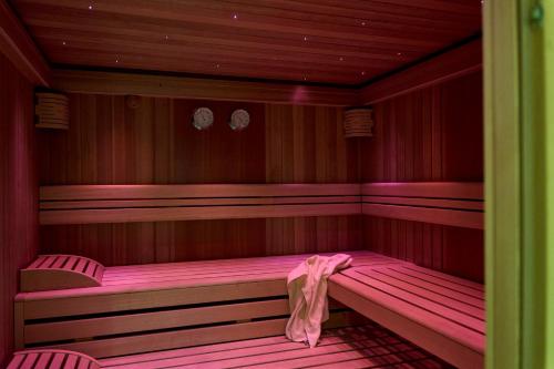 a sauna with pink lighting in a room at Gasthof zum Bad in Langenau