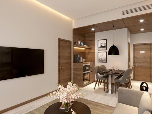 a living room with a large tv on a wall at Kertel Suites Kinshasa in Kinshasa