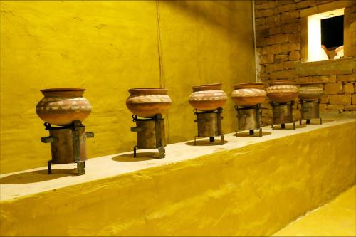 a row of vases on display on a wall at Vijay Bagh in Jaisalmer