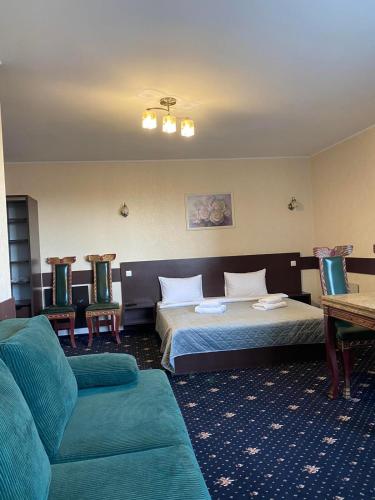 a hotel room with two beds and a couch at Faraon Hotel in Ivano-Frankivsk