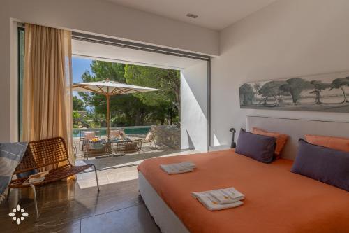 a bedroom with a bed and a view of a patio at Villa EL Azahar by Abahana Luxe in Altea la Vieja