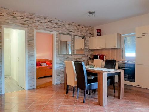 a kitchen and dining room with a table and chairs at Charming Apartment Angela near Malinska in Sveti Anton