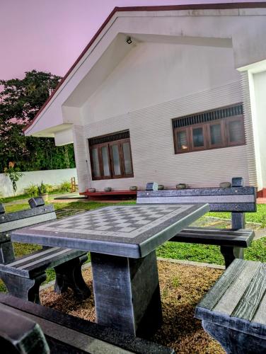 a picnic table in front of a house at Costels Weligama in Weligama
