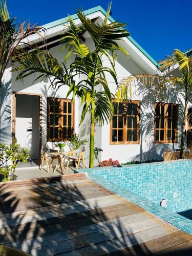a house with a swimming pool in front of it at Kondey Villas in Kondey