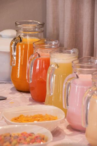 a group of glass jars filled with different colored liquids at Estación Tilcara boutique hotel in Tilcara