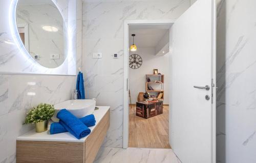 a bathroom with a sink and a mirror at House Seaside Magnolias in Pirovac