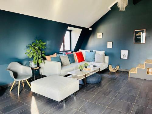 un salon avec un canapé blanc et des chaises dans l'établissement Loft atypique - Vieux Lille, à Lille