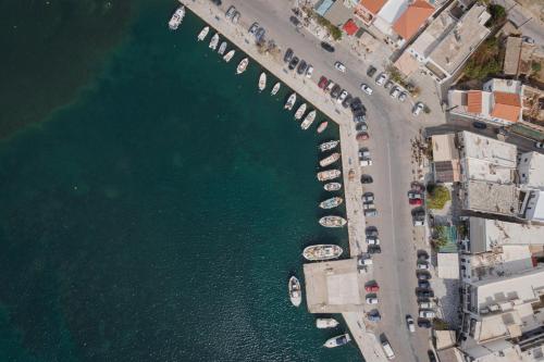 an overhead view of a parking lot next to the water at Porto Sereno Andros Suites in Andros