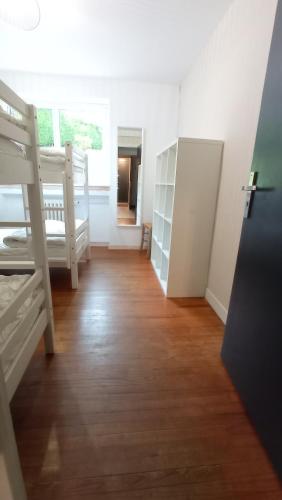 a room with two bunk beds and a wooden floor at Sublime Chalet 14 Pers Spa Extrieur in Cauterets