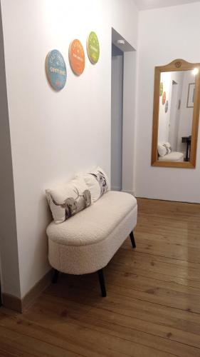 a white room with a bench and a mirror at Sublime Chalet 14 Pers Spa Extrieur in Cauterets