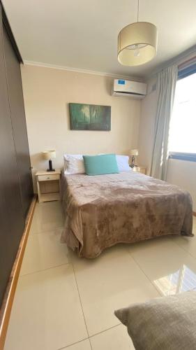 Ένα ή περισσότερα κρεβάτια σε δωμάτιο στο Departamento Edificio Manantiales