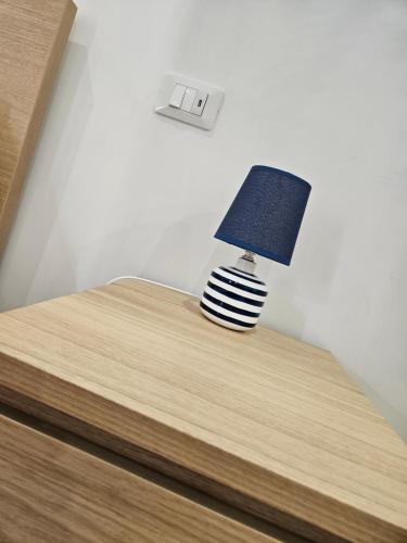 a lamp sitting on top of a bed at Profumi di Sicilia in Cinisi