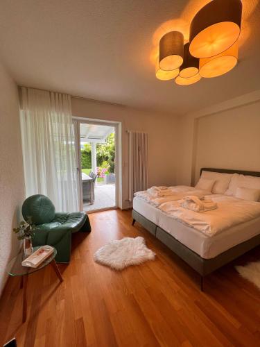 a bedroom with a large bed and a fan at Villa GiNa Apartement in Albbruck