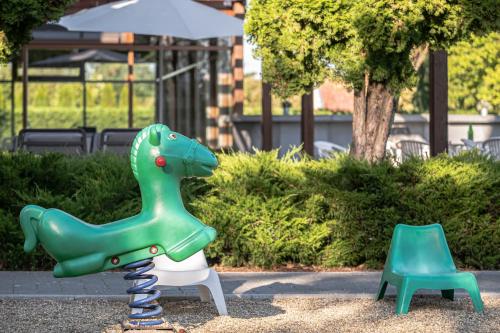 a playground with a plastic dinosaur on a swing at Hercegasszony Birtok in Mezőtúr