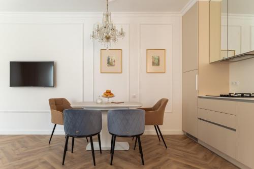 a kitchen and dining room with a table and chairs at "M&D ApartmentsLviv" Ultra Lux Rynok Square, 6person in Lviv