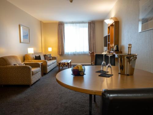 a living room with a table in a hotel room at Future Inn Plymouth in Plymouth