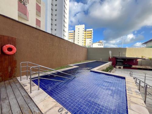 a swimming pool on the side of a building at Flats Vista Mar PontaNegra in Natal