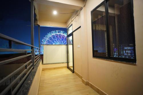 a hallway with a ferris wheel in the background at The Manohar Hotel Budaun in Budaun