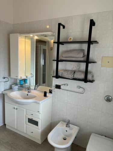 a bathroom with a sink and a toilet and a mirror at Appartamento Le lame in Corte Franca