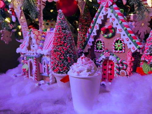 a group of gingerbread houses and trees in the snow at Country Cascades Waterpark Resort in Pigeon Forge
