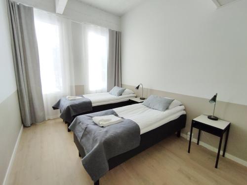 Ένα ή περισσότερα κρεβάτια σε δωμάτιο στο Forenom Aparthotel Varkaus