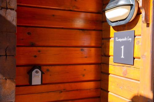 a wooden wall with a sign that reads emergency boy at Three Peaks Log スリーピークス ログ in Hakuba
