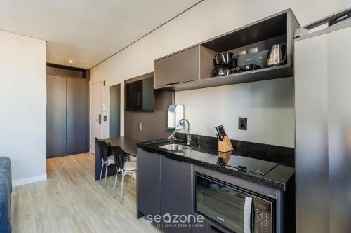 a kitchen with a sink and a counter top at TCO - Apartamentos no Centro Histórico Porto Alegre/RS in Porto Alegre