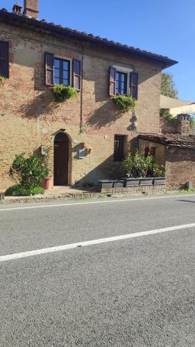 a brick house on the side of a street at Dolce Dimora Siena in Siena