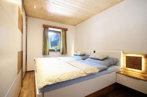 a bed in a small room with a window at Almliesl GAST-719 in Bad Gastein