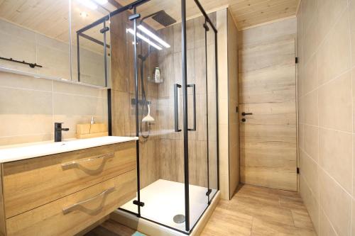 a bathroom with a shower and a sink at Almliesl GAST-719 in Bad Gastein