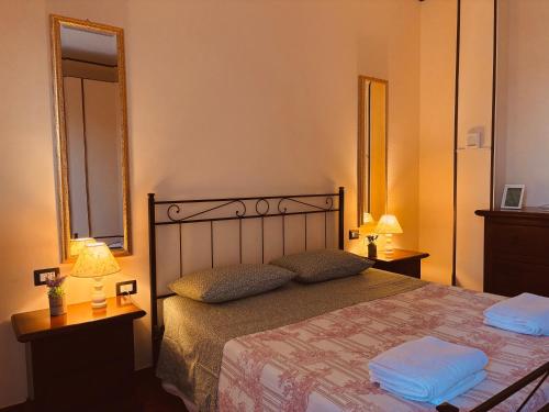 a bedroom with a bed with two pillows and two lamps at La Strada Di Francesco D'Assisi in Bastia Umbra
